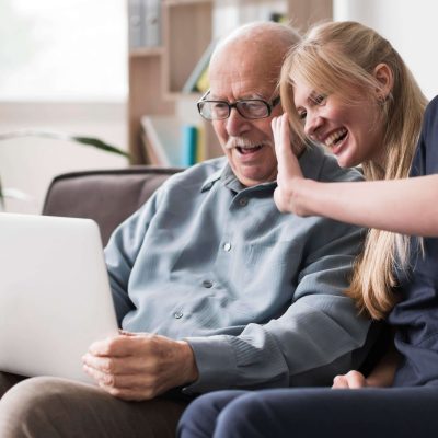 smiley-old-man-nurse-having-video-call-laptop (1)